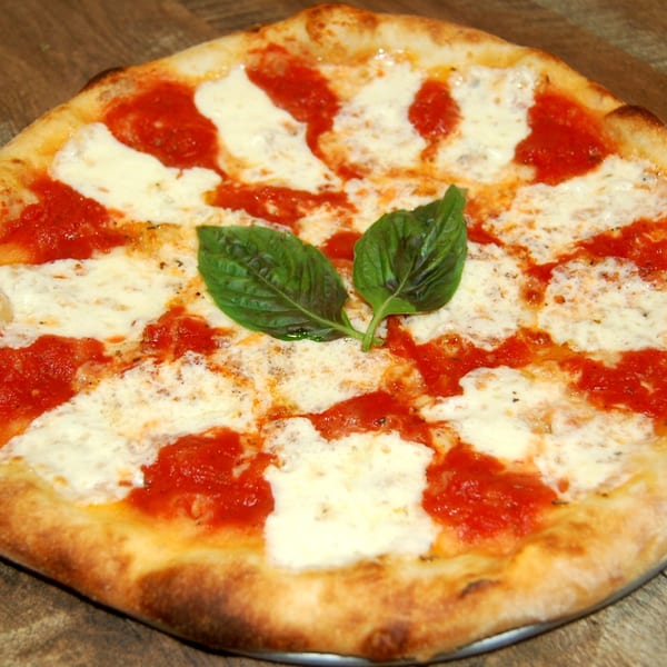 A freshly baked Danny's Pizzeria Margherita pizza with bright red sauce, white mozzarella, and basil leaves.